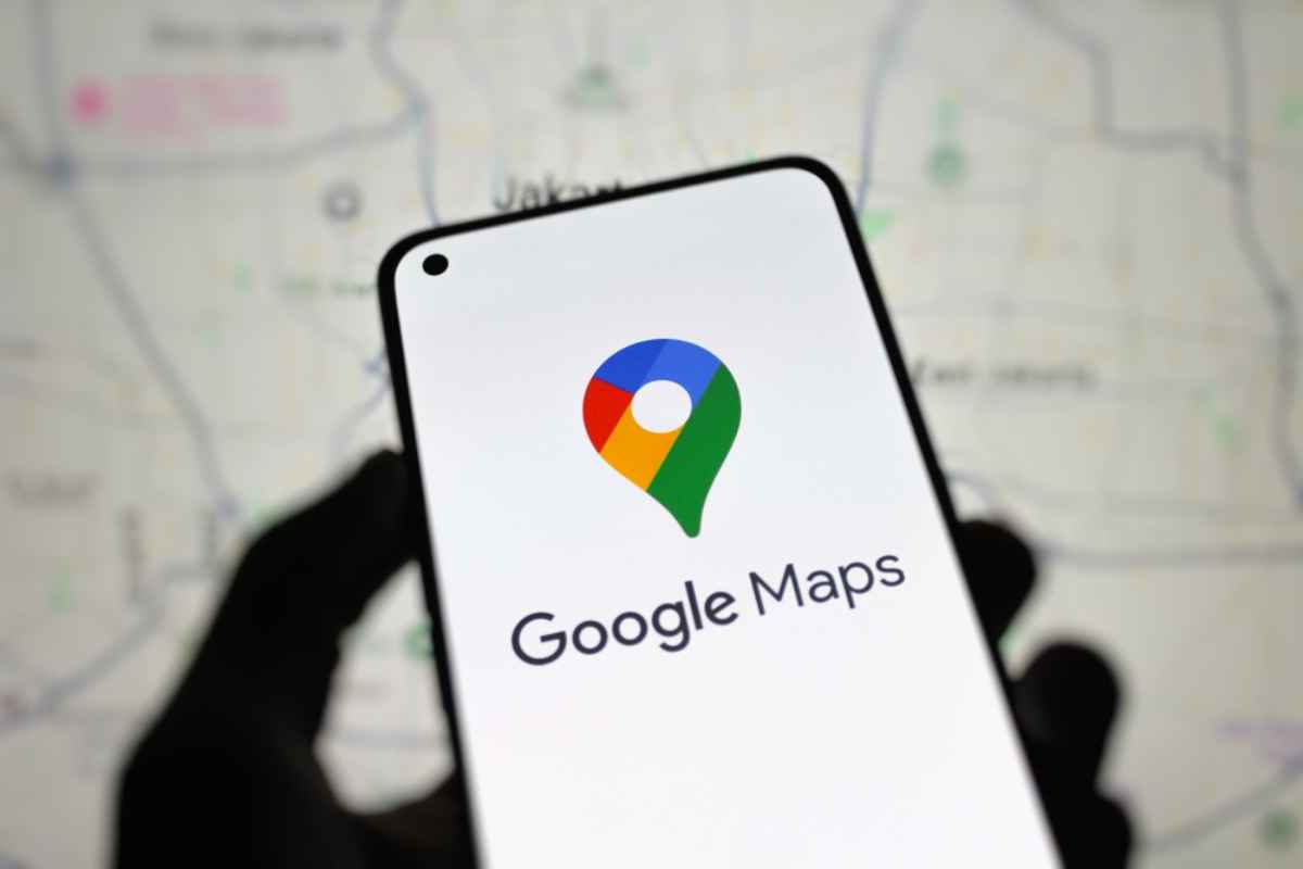 Smartphone displaying the Google Maps logo with a blurred map in the background.
