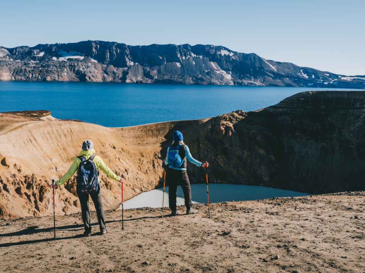 Hikers overlooking Víti crater and Öskjuvatn lake near Askja on Iceland’s F88.