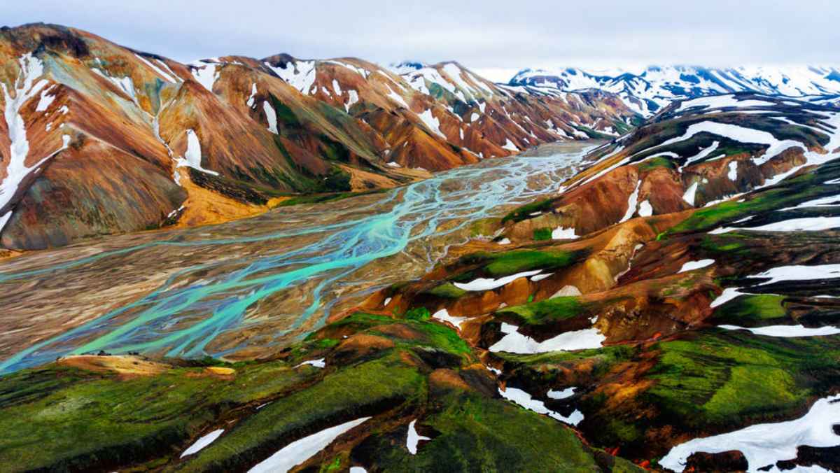 Aerial view of Landmannalaugar’s colorful ridges and turquoise braided rivers from the F208 area.