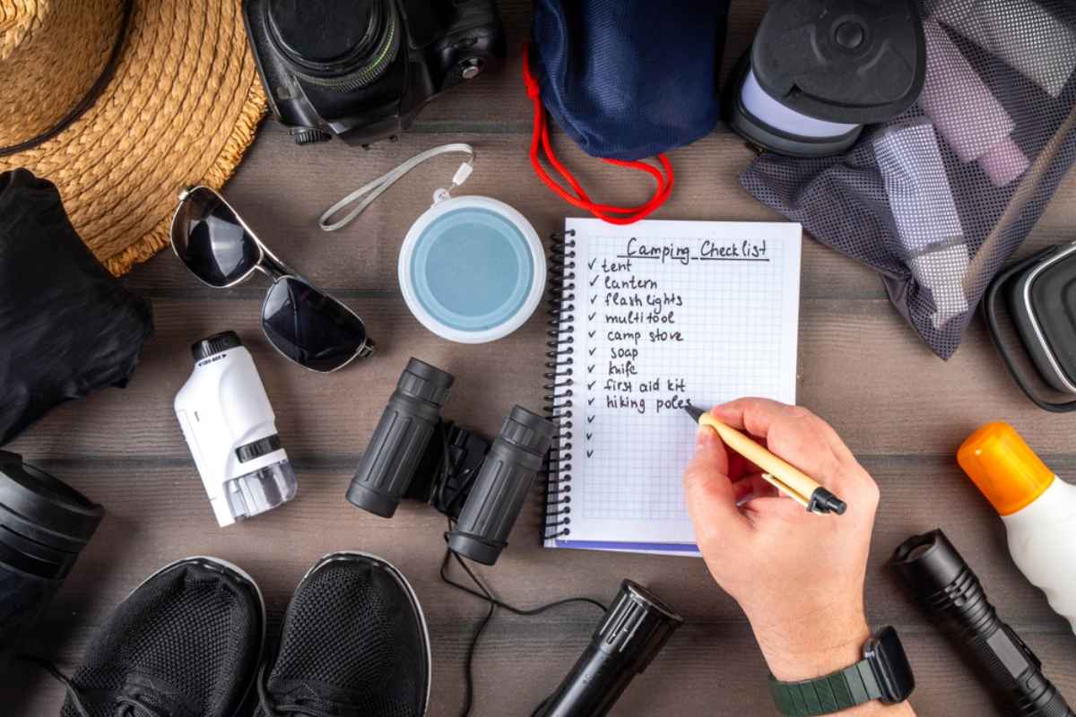 Travel packing checklist with camping gear, binoculars, and outdoor essentials
